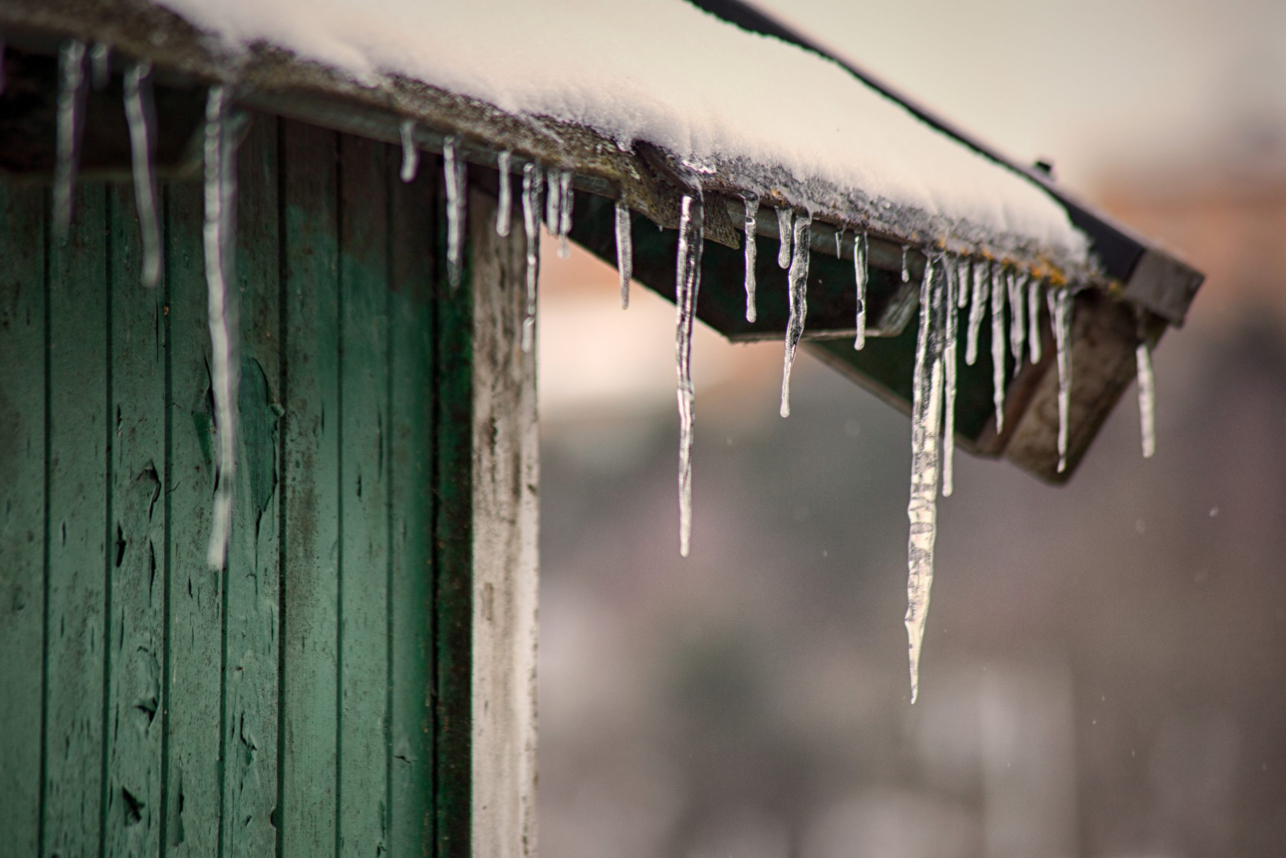 icicles forming on the roof of a house