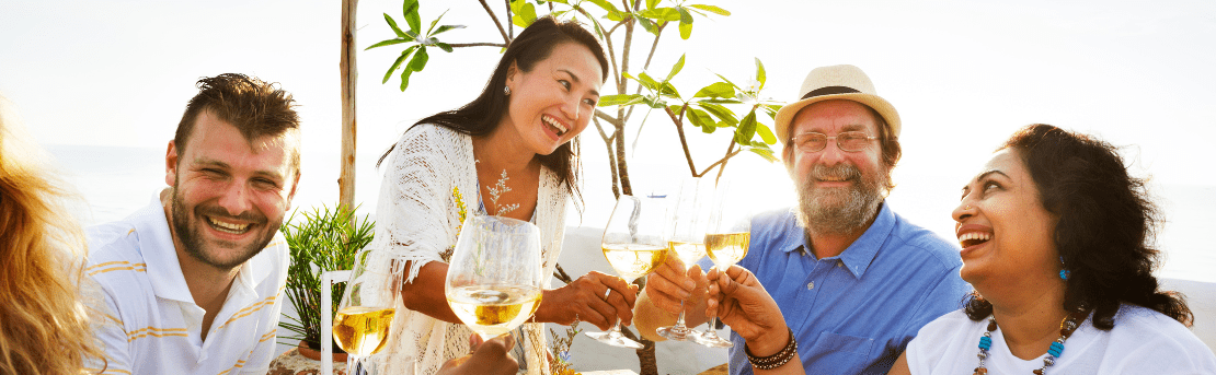 Adults clinking wine glasses together in a celebratory toast