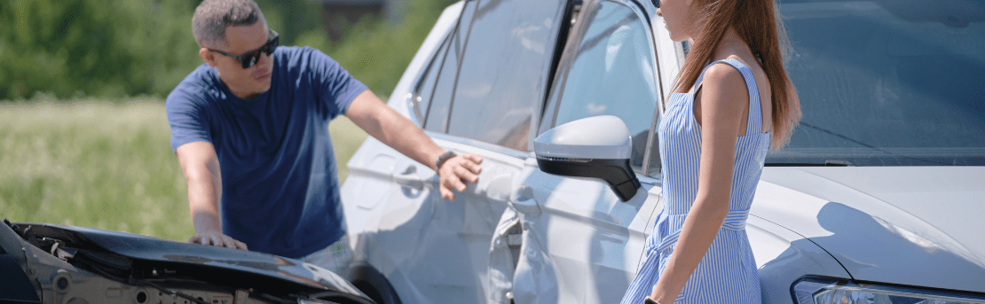 Two people evaluating a car accident