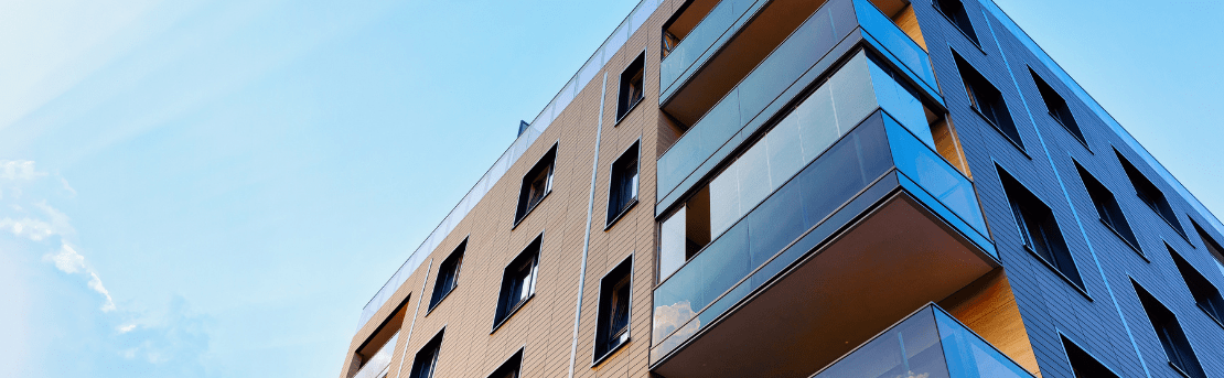 Condo complex against bright, blue sky.