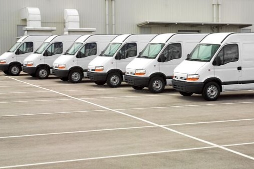 fleet of six white utility vans