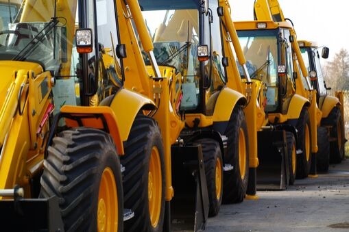 three yellow bulldozers