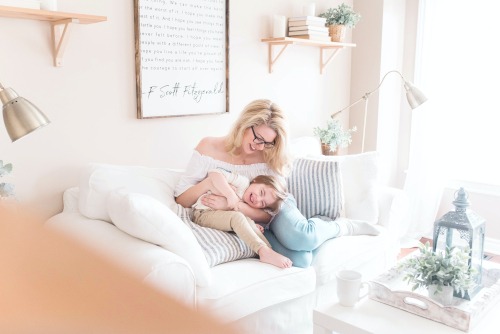 a mom and her son laying on the couch