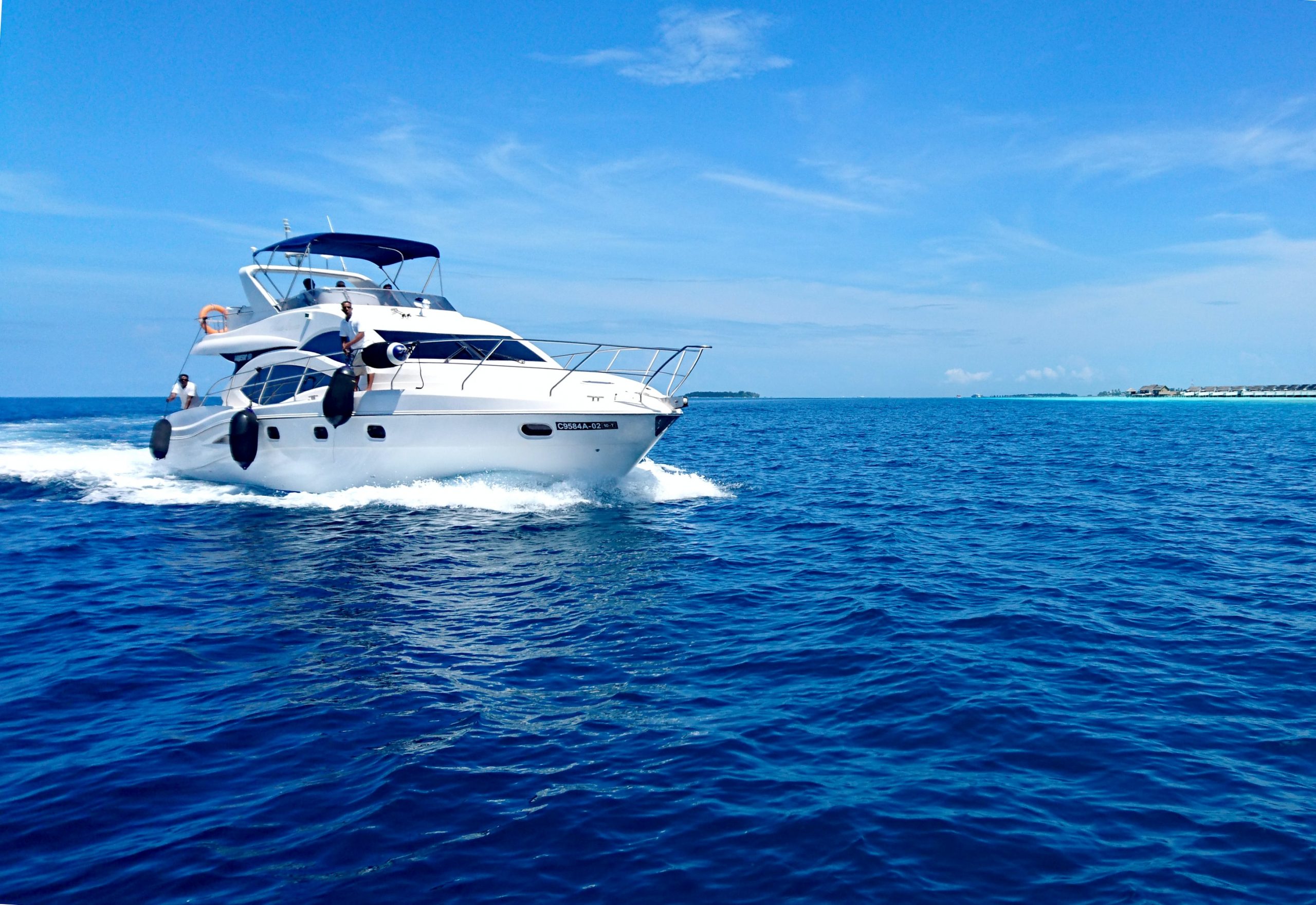 Men on a yacht cruising through the ocean