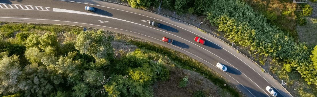 An aerial shot of cars driving on the interstate.