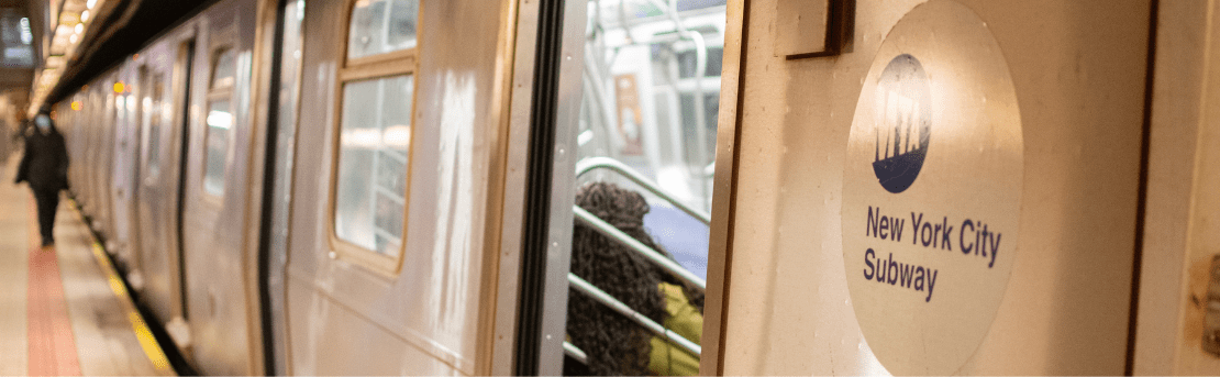 Close-up of New York City Transit train with open doors on the track.